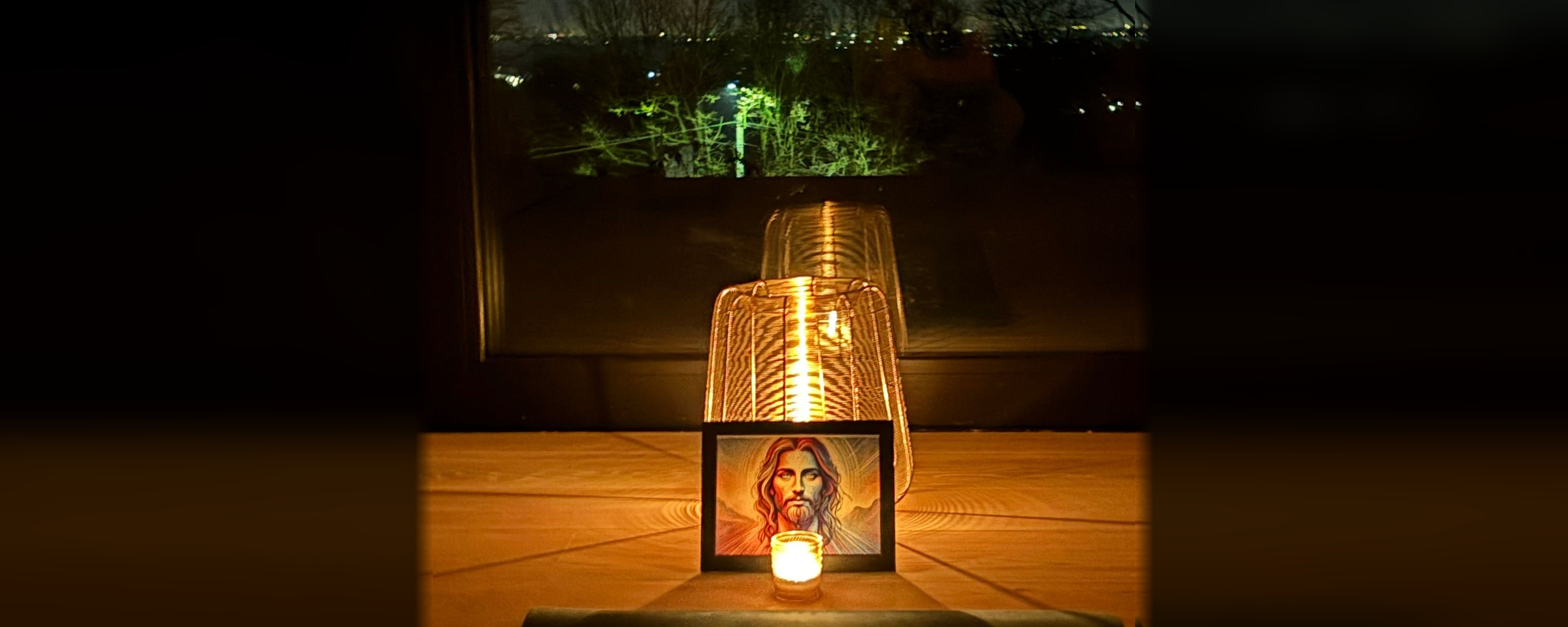 Candle and portrait by window
